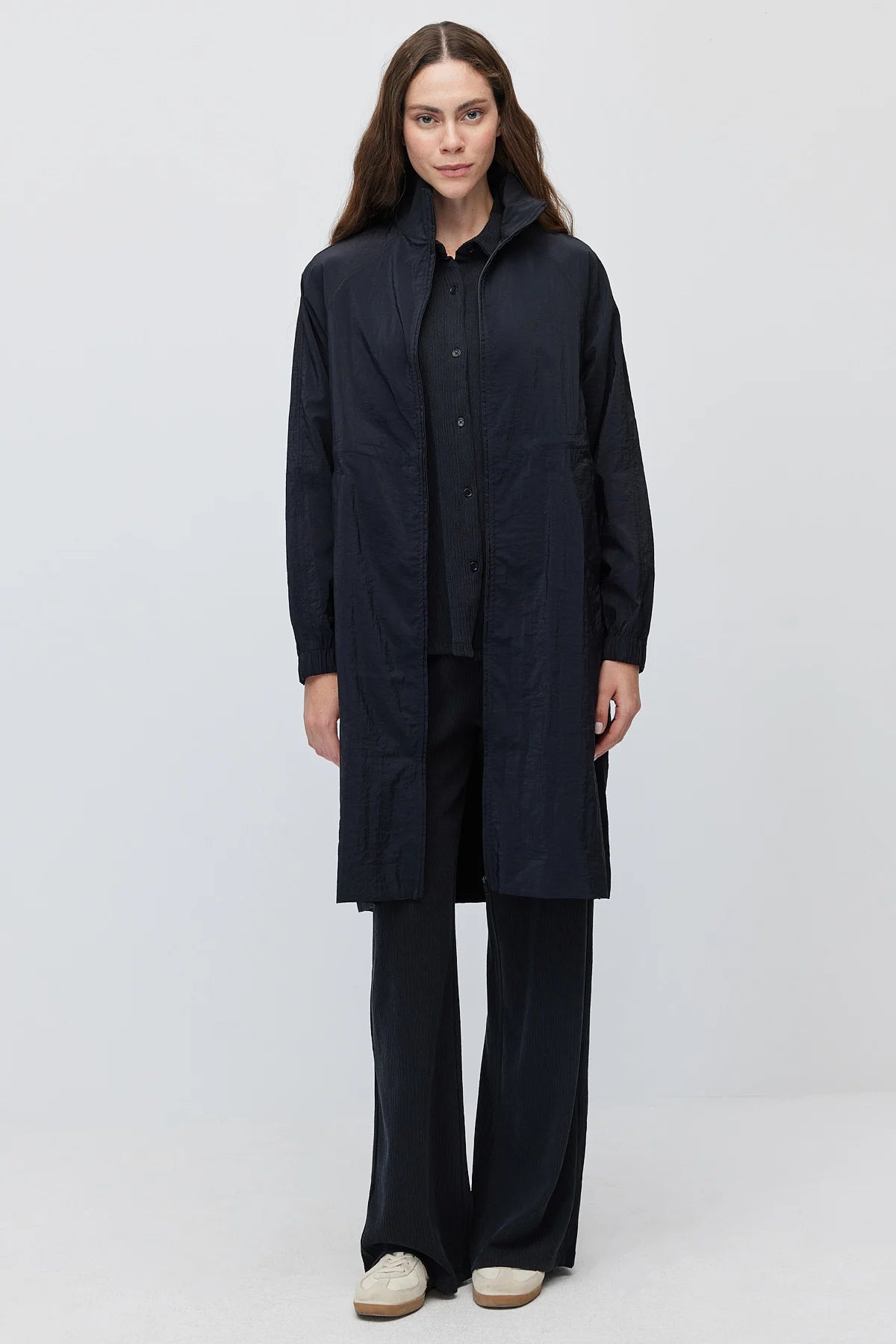 Women's long, zip-up raincoat with a stand-up collar